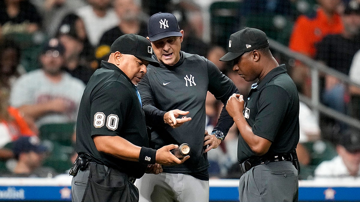 Aaron Boone gestures to the bat
