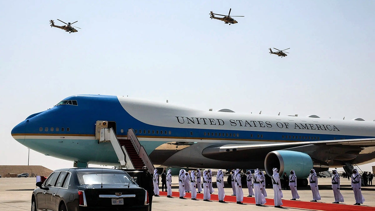 Air Force One is on the tarmac, with military members outside
