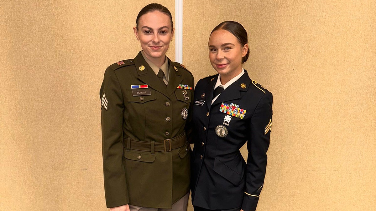 Alexia Rodrigues posing in uniform with another woman in military wear.