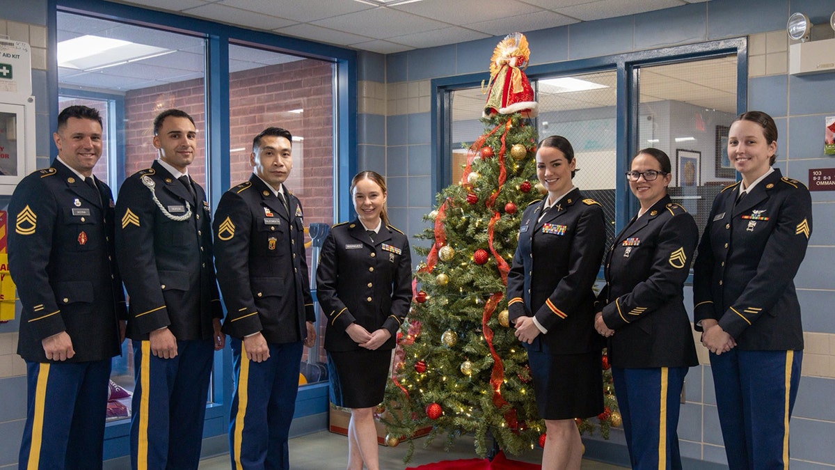 Alexia Rodrigues posing in uniform with others with her team during the holidays.