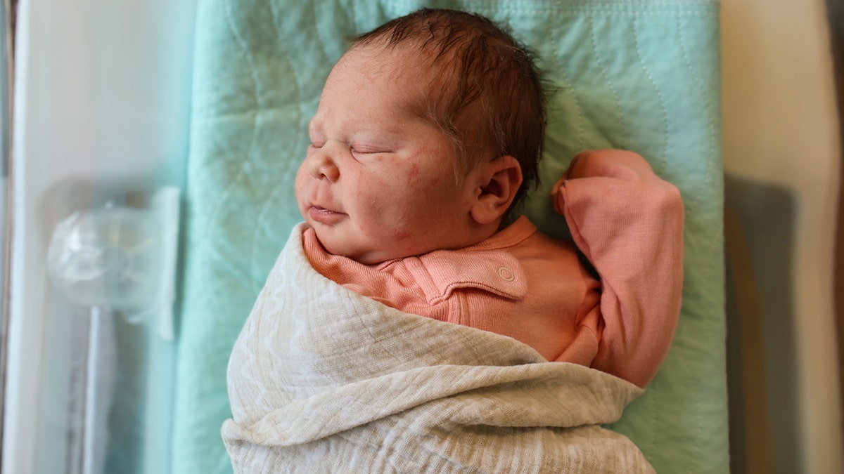Baby Matilda Rotunda, AKA "Tilly" or "McTilly" seen swaddled in hospital after being born in a McDonald's parking lot