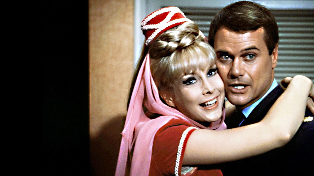 Barbara Eden as Jeannie embracing Larry Hagman.