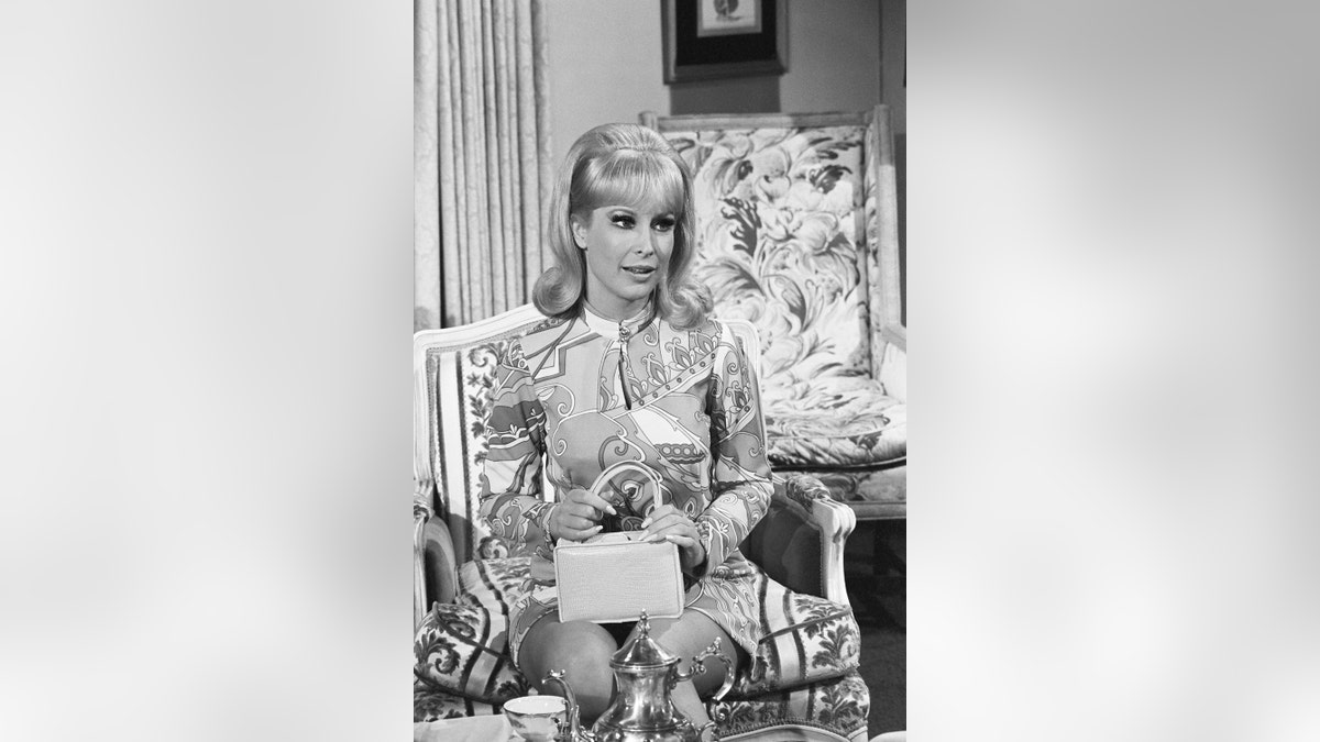 芭芭拉·伊甸園（Barbara Eden）用錢包掩蓋了她的肚子。