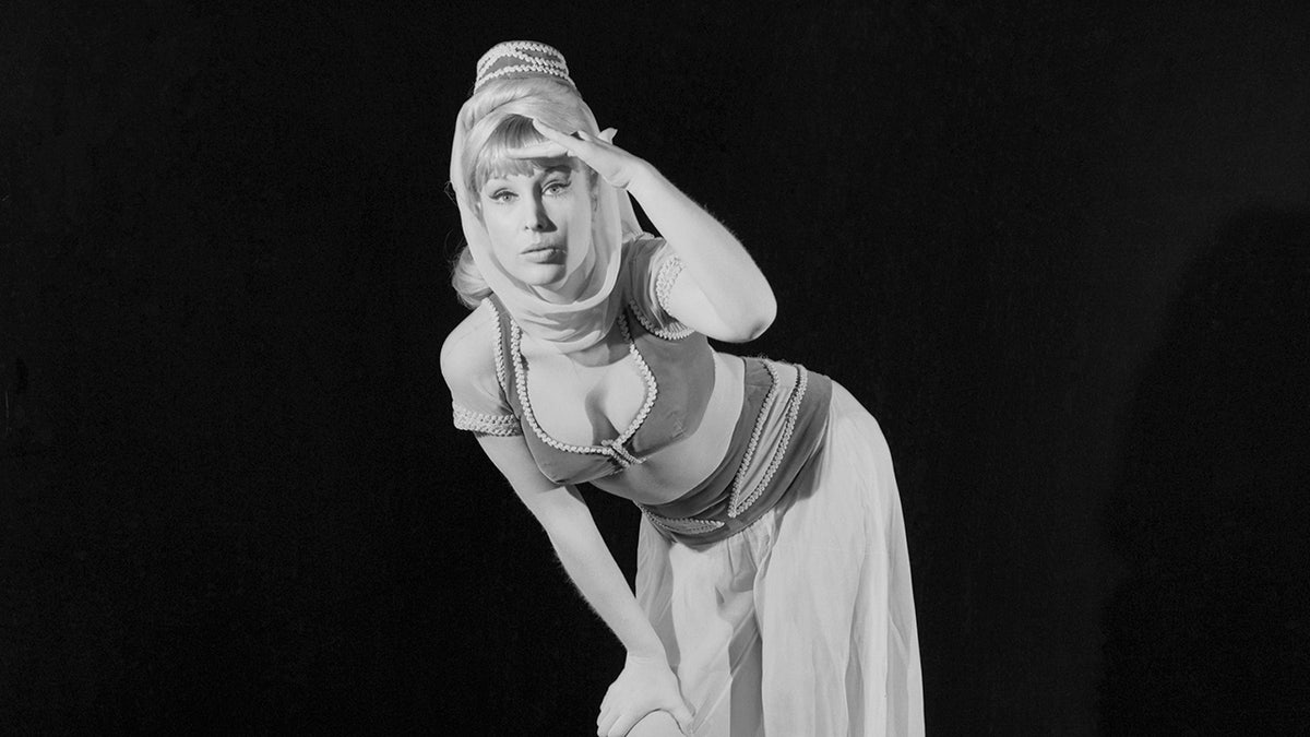 Barbara Eden searching as Jeannie in costume.