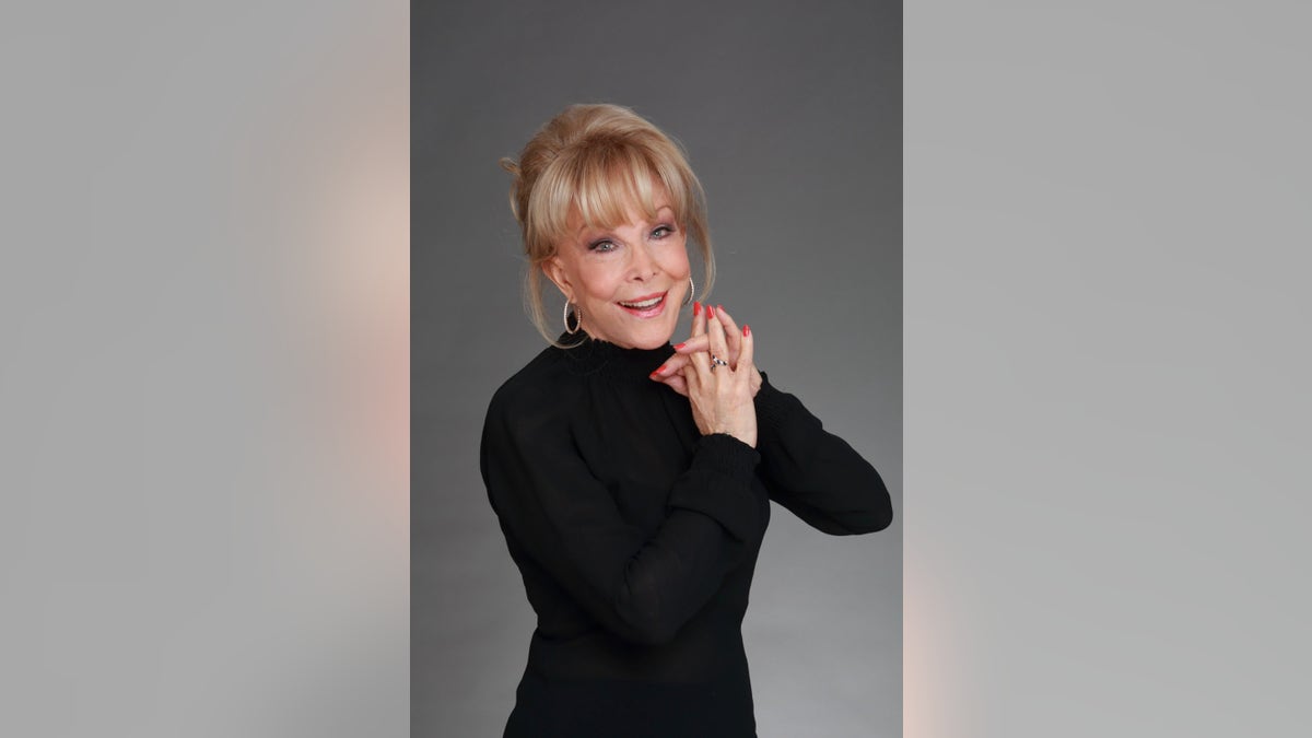 Barbara Eden posing in black.