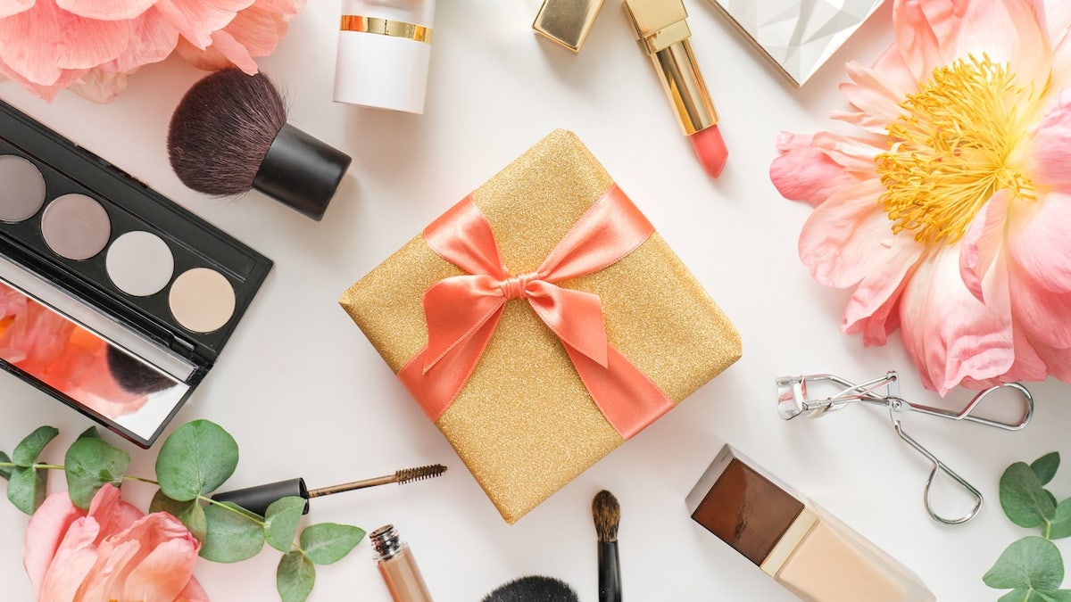 make up products with gift box on white background