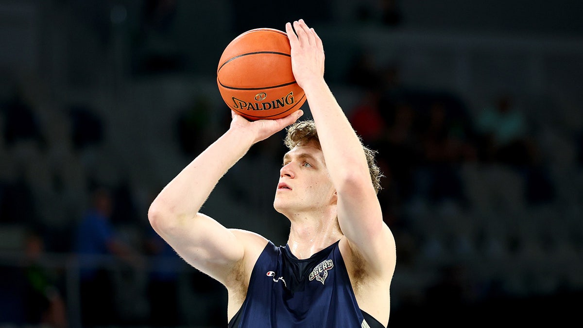 Ben Griscti warms up before a basketball game