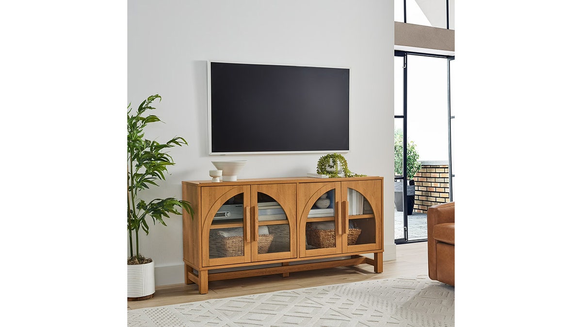 Add a modern touch to your TV setup with an arched TV stand. 