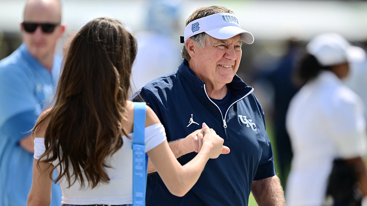 Bill Belichick smiles with Jordon Hudson