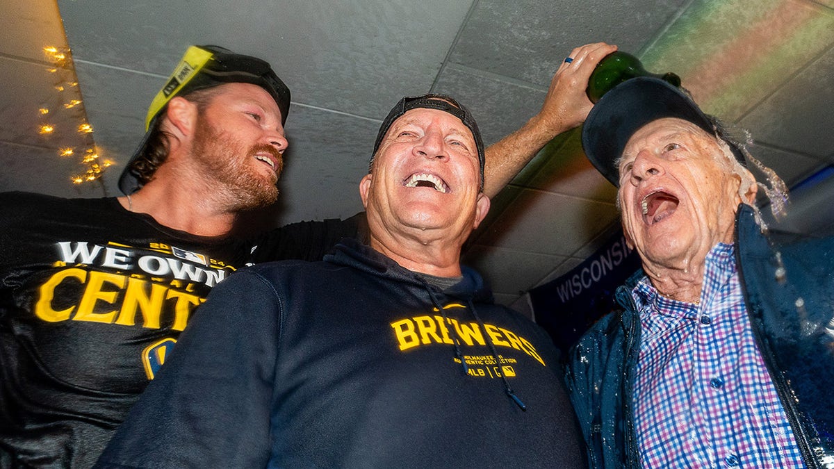 Brandon Woodruff pours champagne on Bob Oker