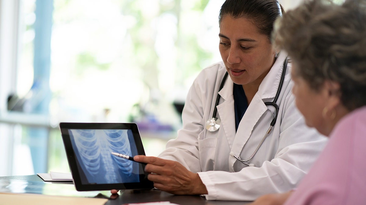 Woman receiving X-ray results from doctor