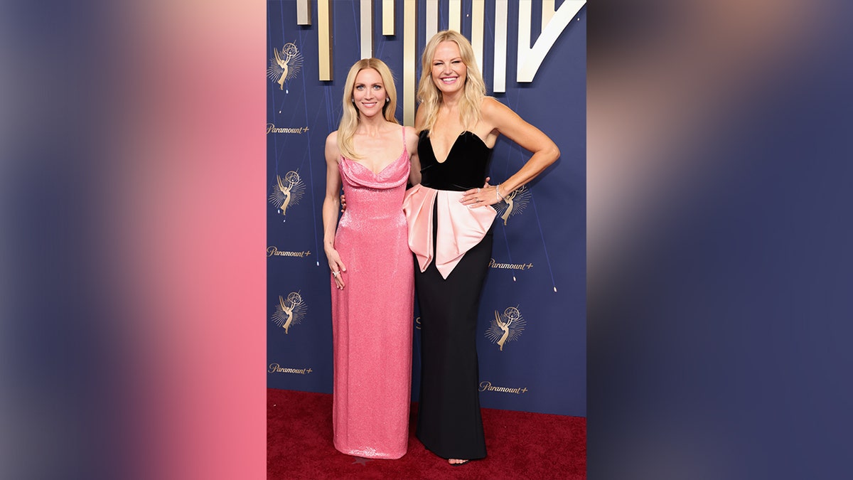 Brittany Snow and Malin Akerman posing together at the 2025 Emmy Awards.