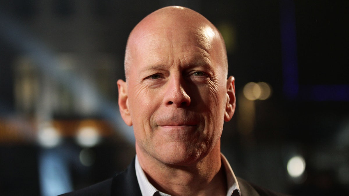 A close-up of Bruce Willis staring into the camera and smiling.