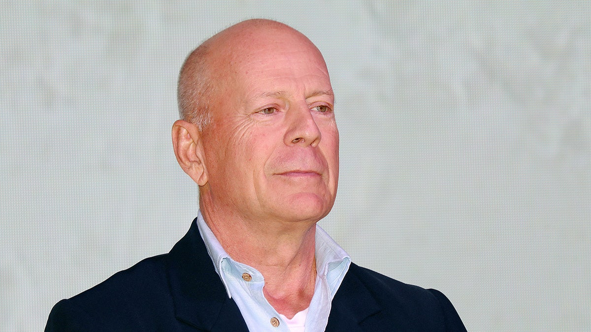 Bruce Willis looking to the side serious.