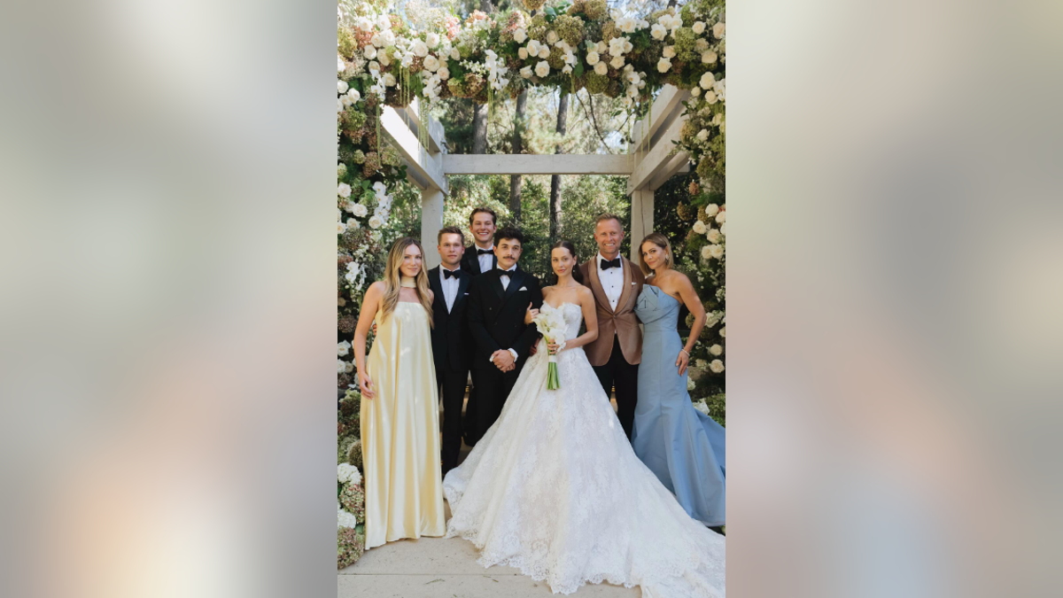 The Bure family posing at Natasha Bure and Bradley Steven Perry's wedding. 