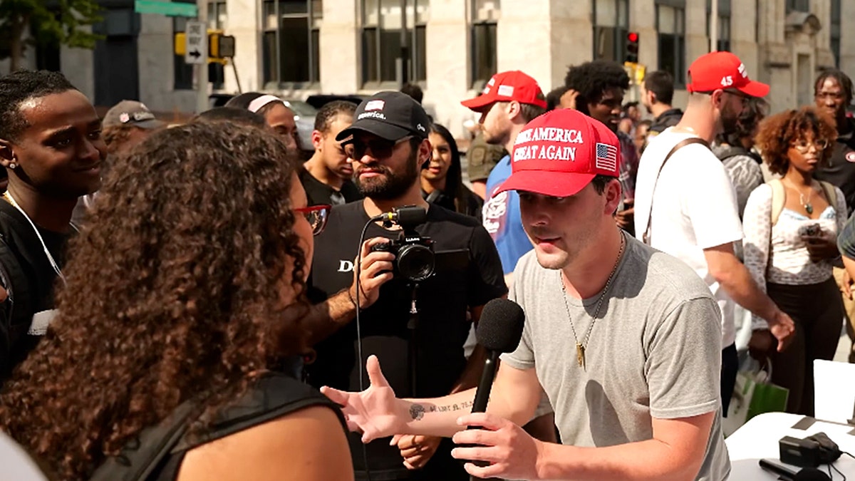 journalist Cameron Higby debating a student in Georgia