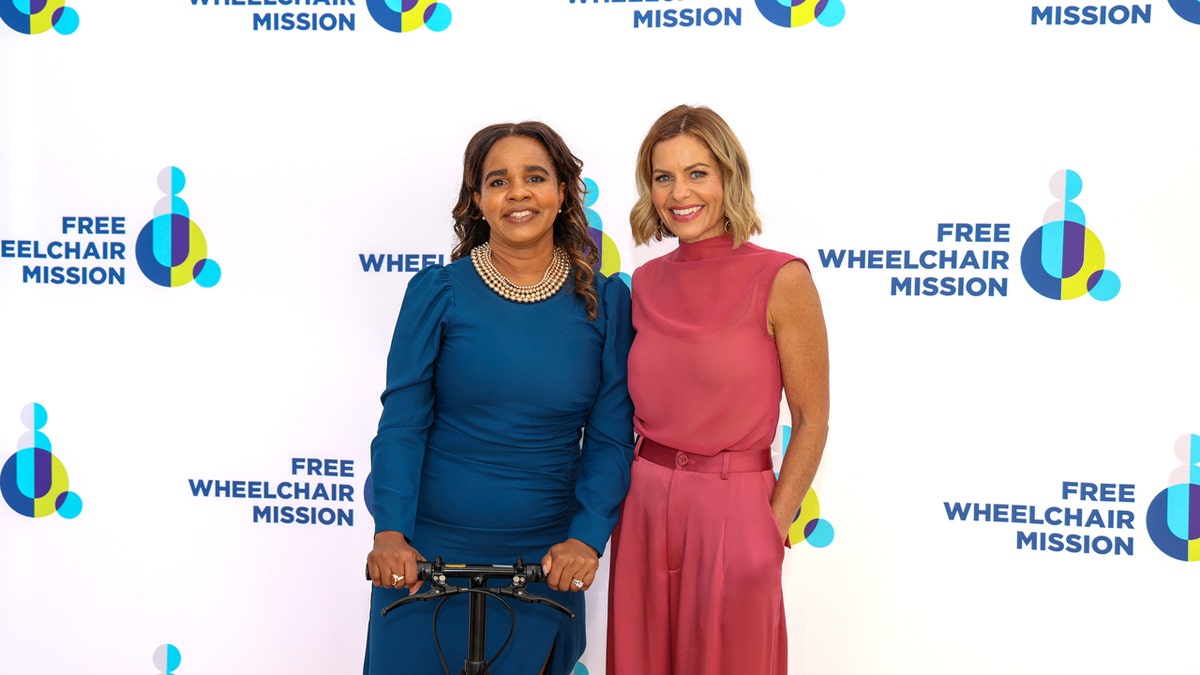 Candace Cameron and the CEO of Free Wheelchair Mission pose for a photo