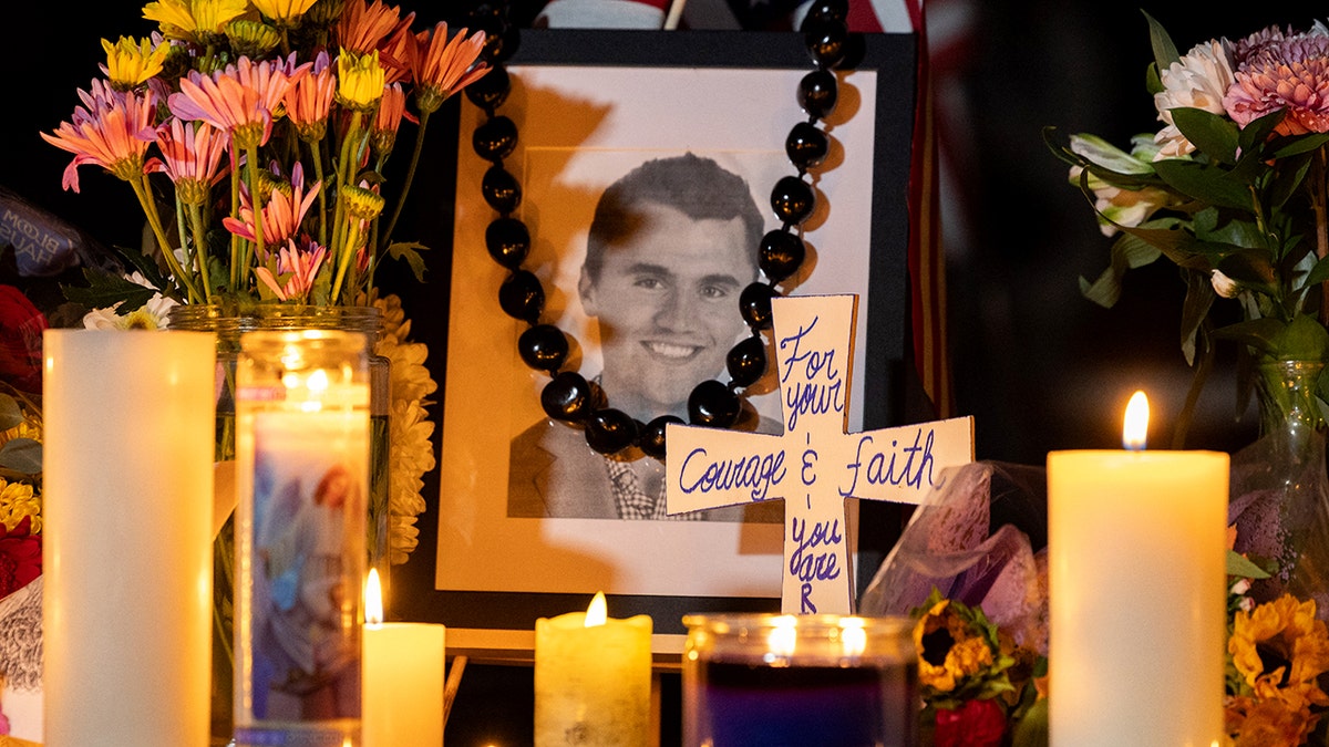 Rosary beads cover Charlie Kirk's photo at the temporary memorial.