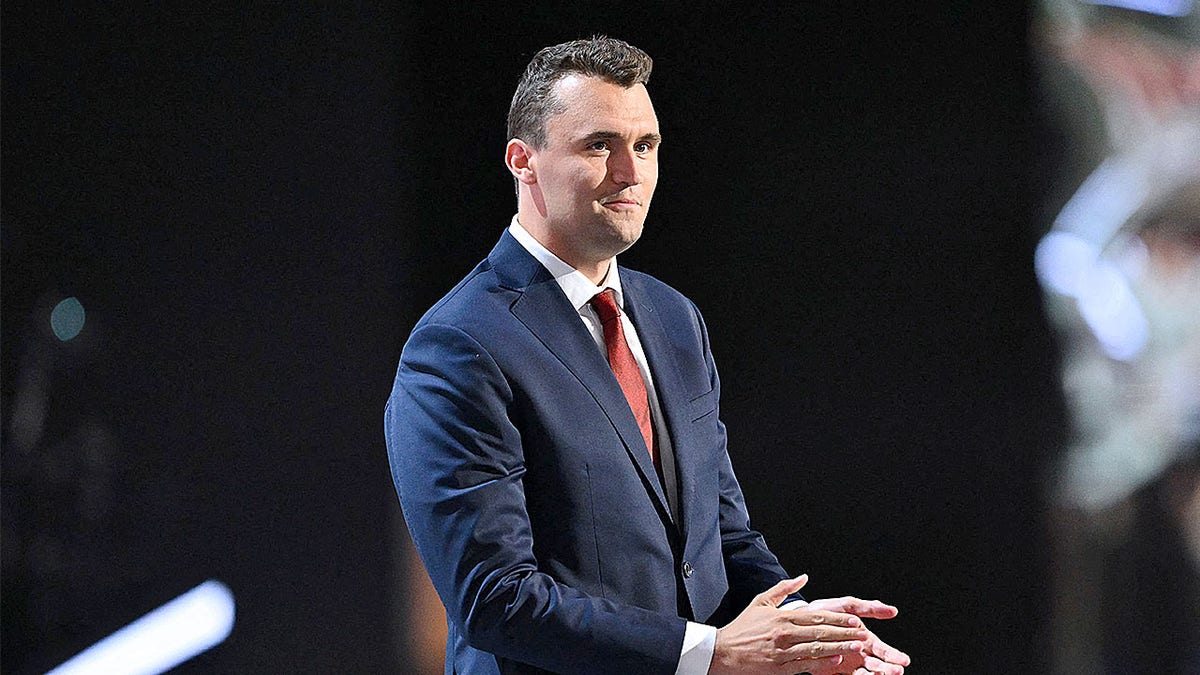 Charlie Kirk looks on