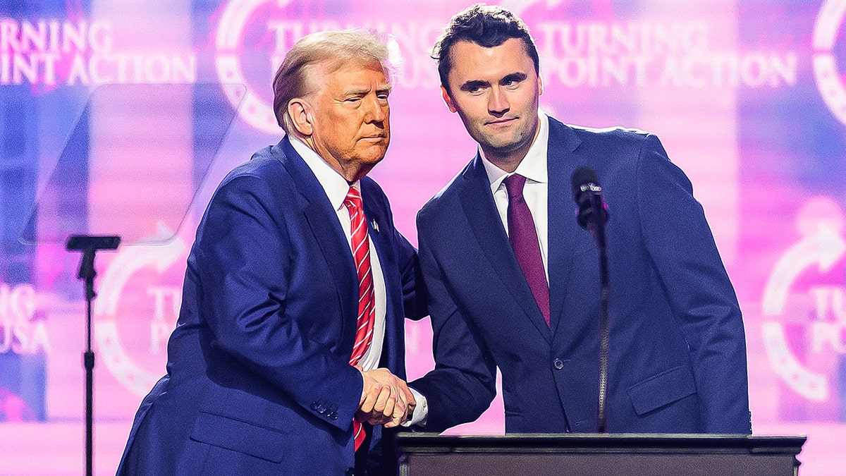 Donald Trump shakes hands with Charlie Kirk