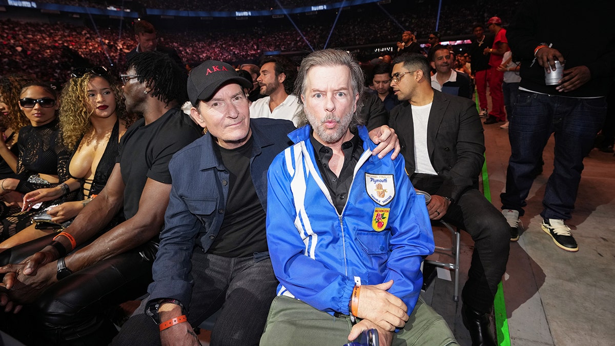 Charlie Sheen with his arm around David Spade.