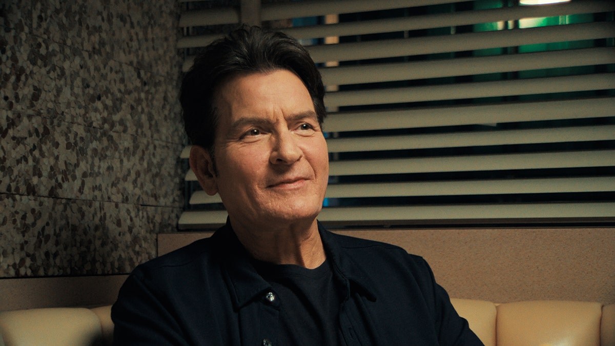 A close-up of Charlie Sheen inside a diner.
