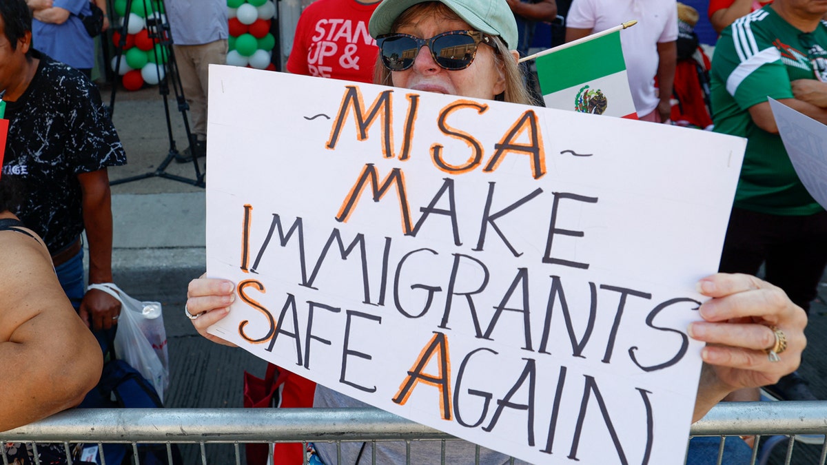 Protester holds up sign supporting immigrants
