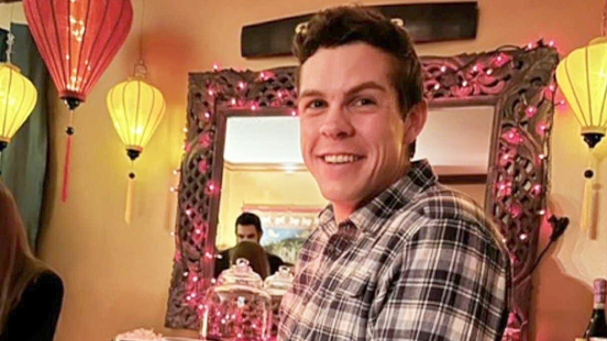 Photo of Christopher Perry, 32-year-old groom who died five months before his wedding, seen smiling at restaurant.