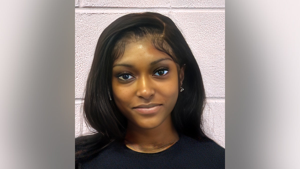 Dacara Thompson in black shirt standing against a wall