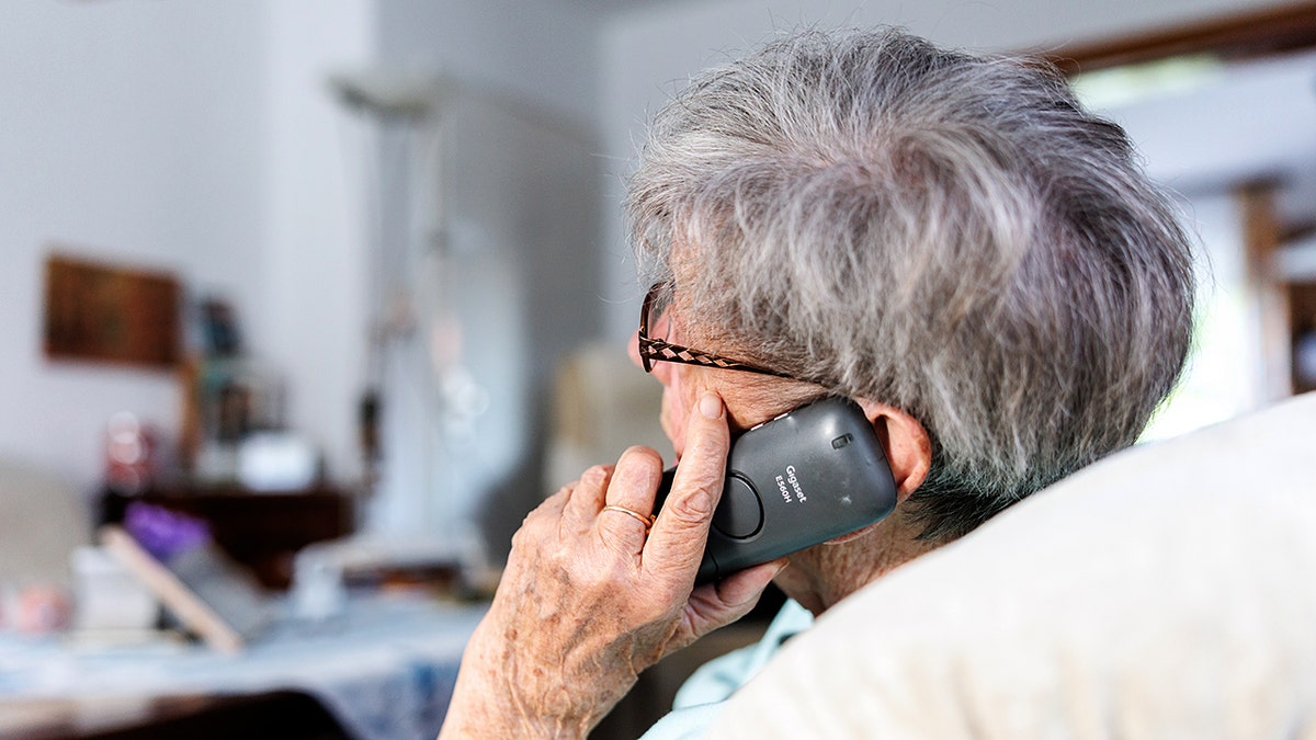An elderly person on the phone