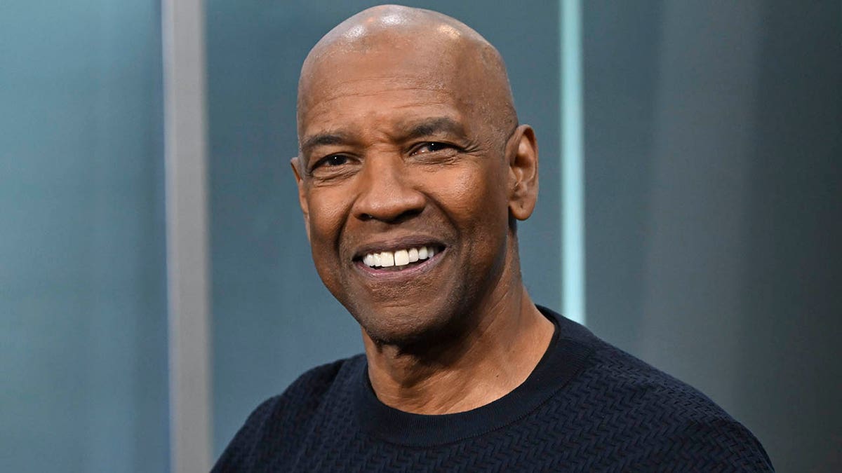 A close-up of Denzel Washington smiling.
