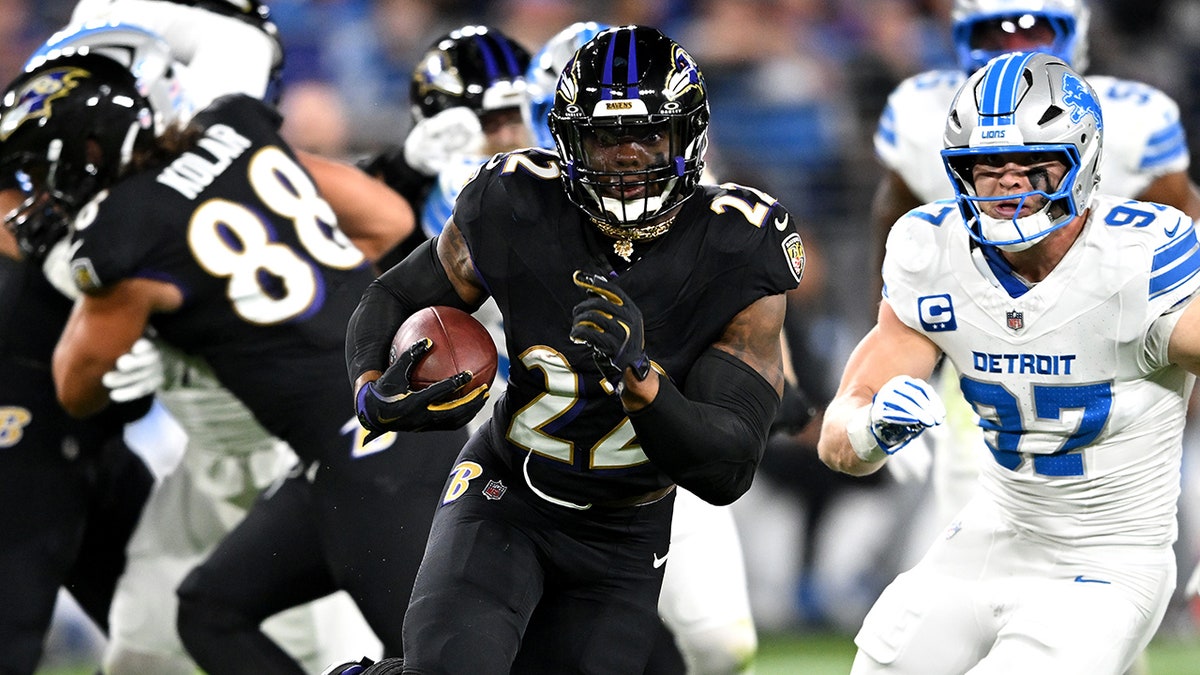 Derrick Henry runs with football