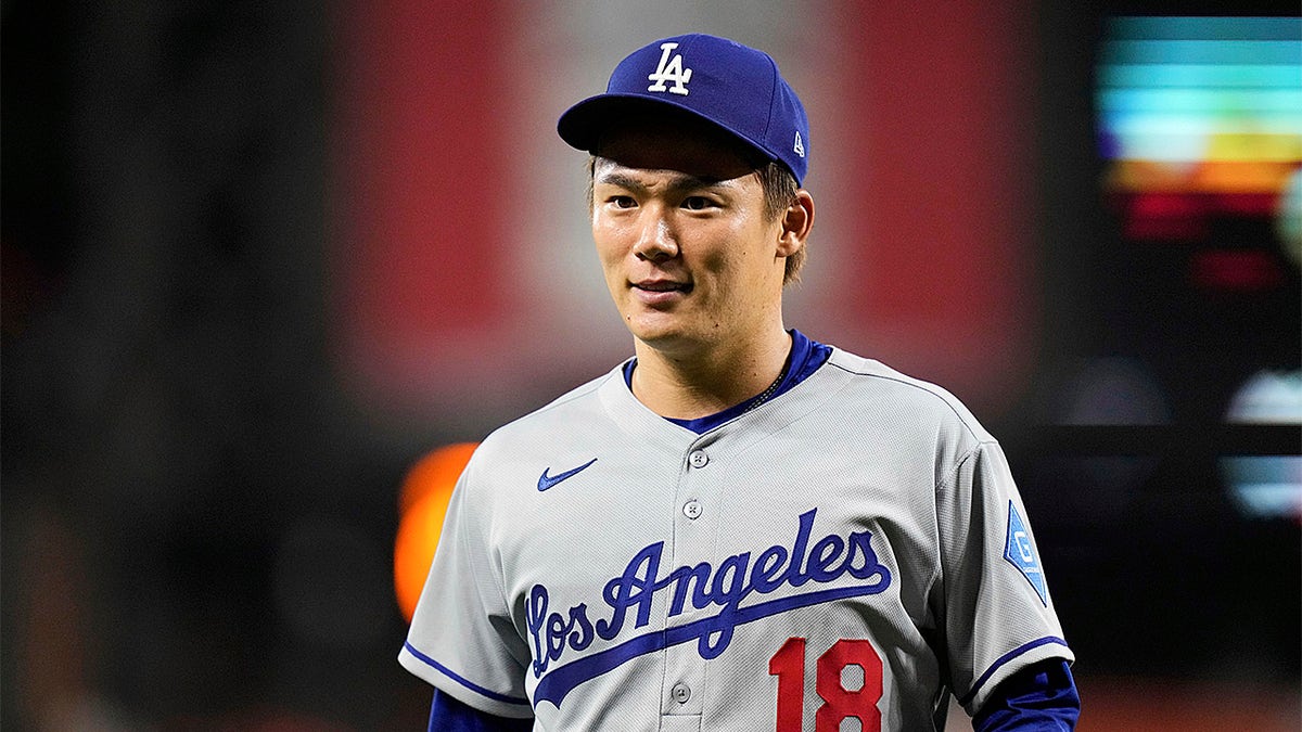 Yoshinobu Yamamoto looks on