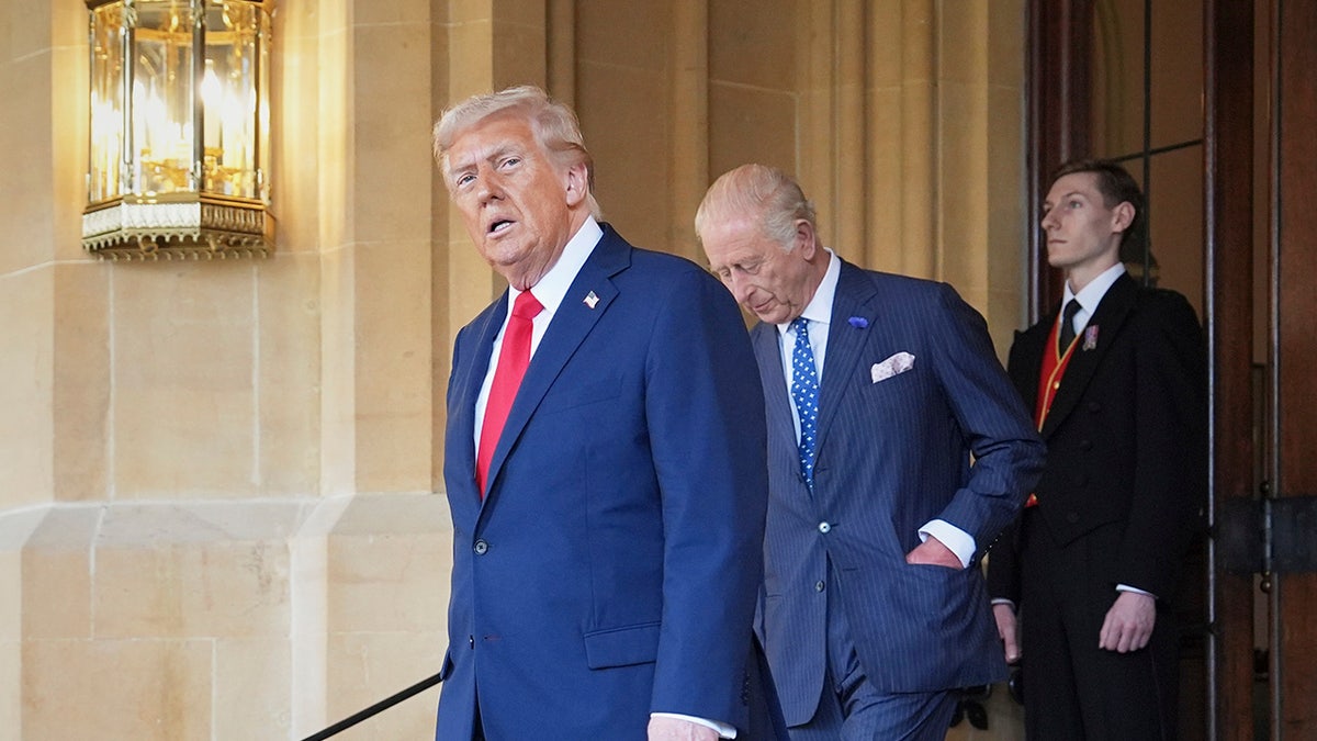 Donald Trump walking with King Charles behind him