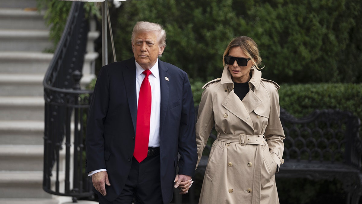 Donald Trump and Melania Trump standing together and speaking to reporters.