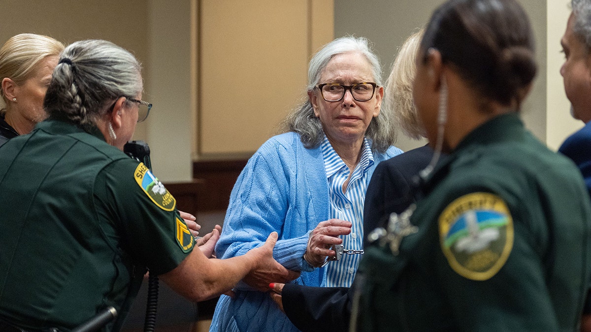 Authorities escort Donna Adelson out of courtroom