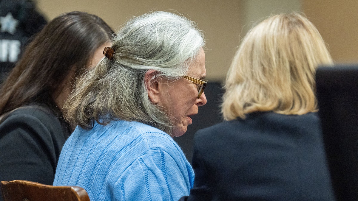 Donna Adelson in blue sweater crying in court