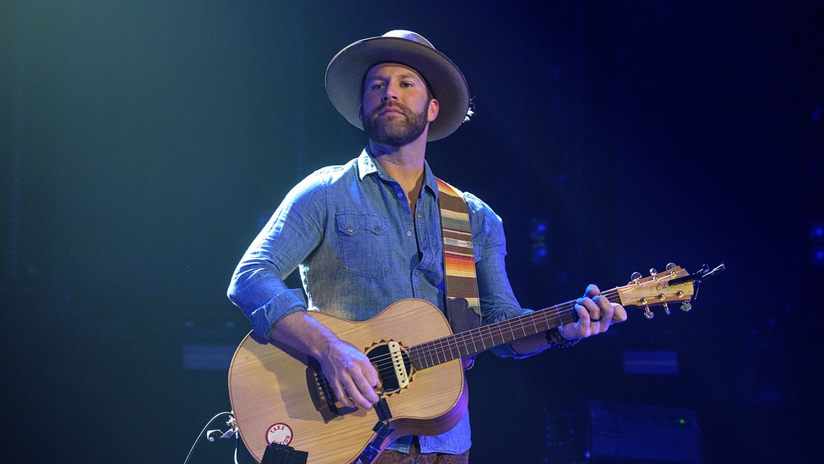 Drake White plays guitar during the concert.