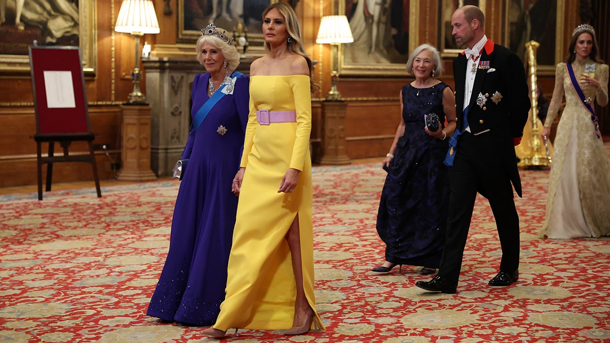 Melania Trump walking alongside Queen Camilla while entering the State Banquet.