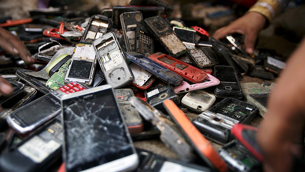 A pile of broken cell phones