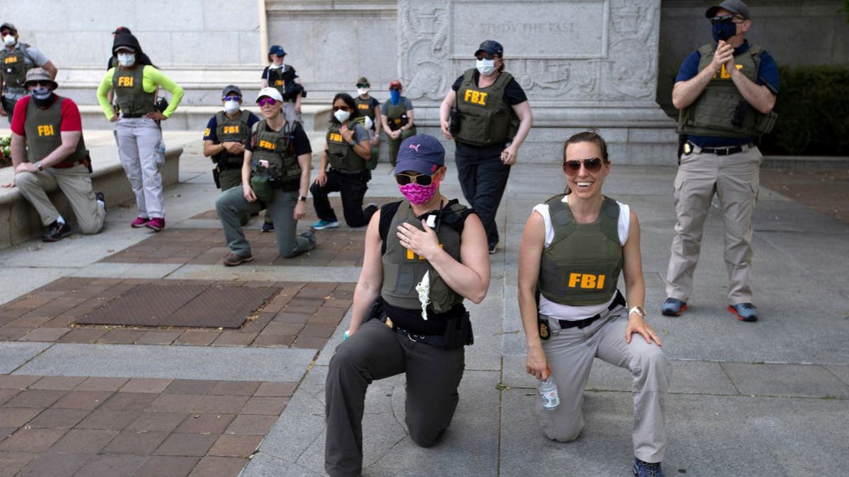 FBI agents kneeling with demonstrators at a George Floyd protest in Washington, D.C., June 2020.