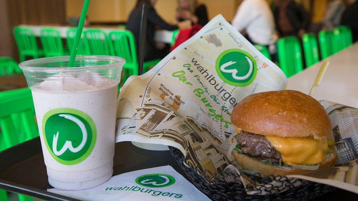 Wahlburgers' Our Burger next to milkshake