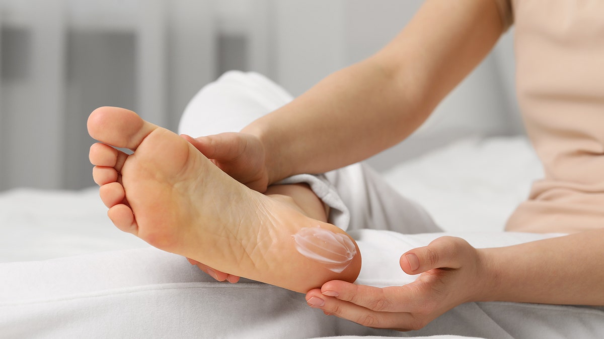 woman lotions foot