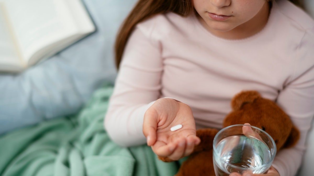 Girl taking pill