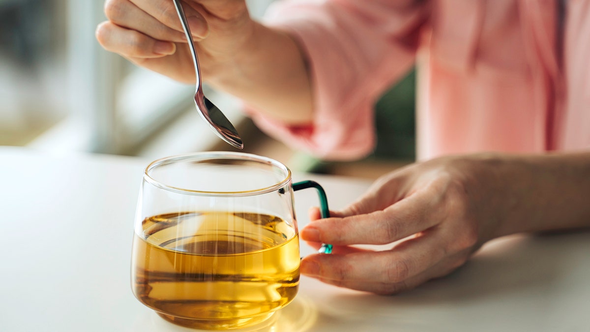 Person prepared a cup of green tea, the components of which were ued in a recent study looking at food-based microbeads that helped with weight loss and fat loss.