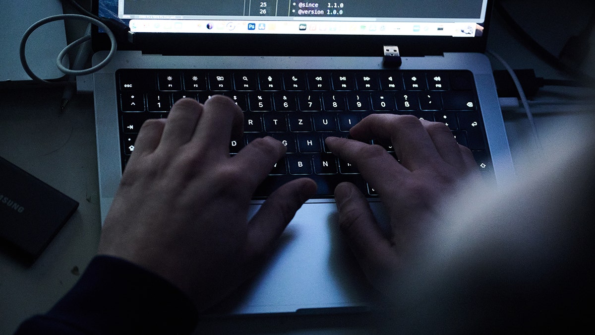 Hacker typing on a keyboard.