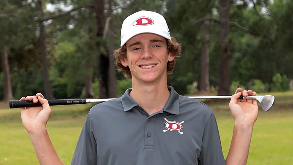 Hadden Kelly poses with golf club
