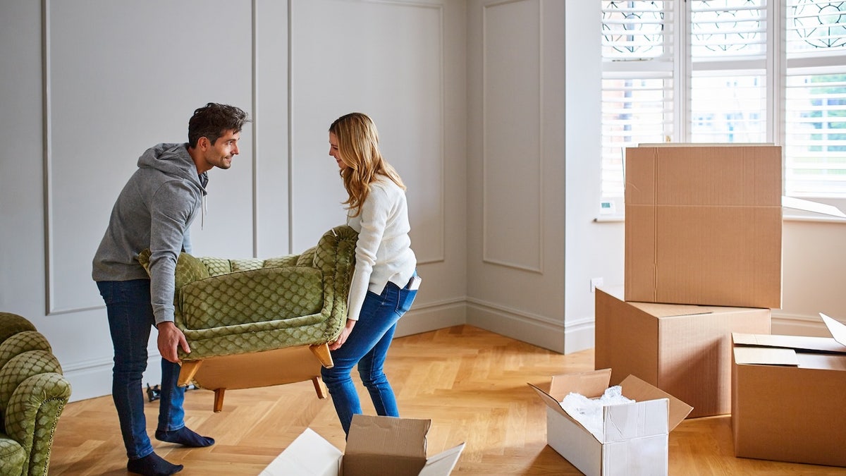 couple unpacking new chair