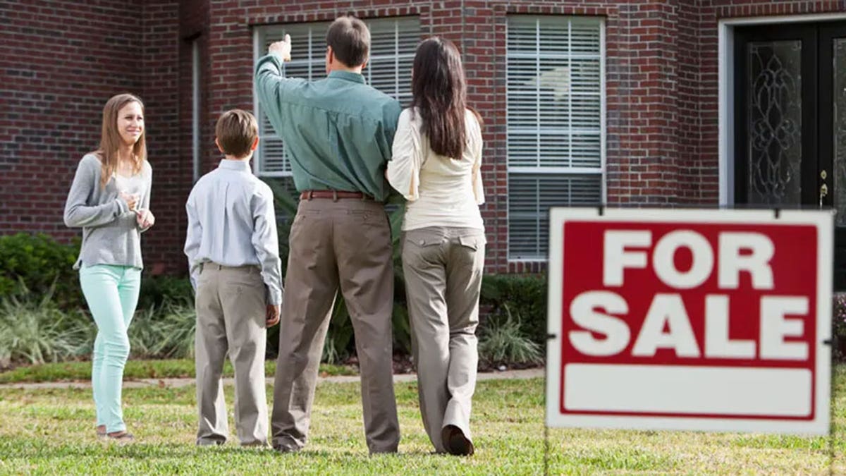 Family looks at house for sale