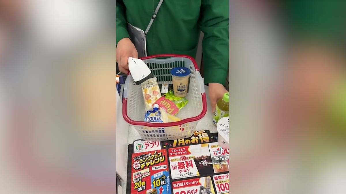 7-Eleven worker in Japan scans basket full of food items purchased by model and content creator Summer Marshall on a recent trip to Tokyo.